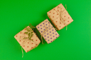 Decorated gift box on a green background, flat lay top view