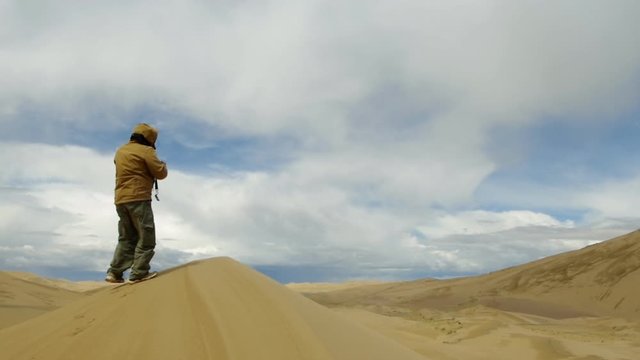 Tourist  taking pictures to Dunes at gobi desert, Mongol Els.