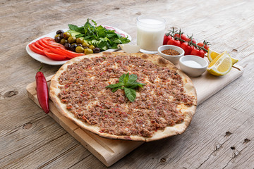 Manakish Arabian food; Lebanese food of Lahme bajeen manouche; Meat pita with veggies and yougurt