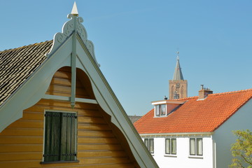 Obraz premium Historic houses located inside the fortified town of Naarden, Netherlands, with the clock tower of the Grote Kerk church in the background