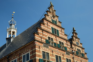 Close-up on the top of the City Hall (Stadhuis, built in 1601), with carvings, Naarden, Netherlands. This hall nowadays is used as a wedding Hall.