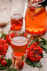 Autumn or winter hot tea with berries, warming drink in glass cup, seasonal calmness, cozy tea party concept
