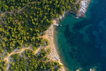 Aerial drone view of beach umbrellas and sunbeds