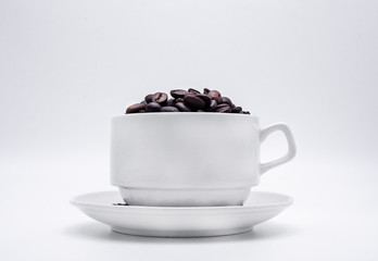 coffee beans in the cup on white background