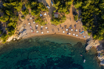 Aerial drone view of beach umbrellas and sunbeds