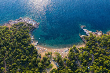 Aerial drone view of beach umbrellas and sunbeds