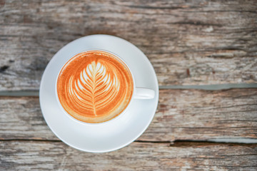 A cup of latte on wooden table stock photo