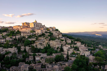 Fototapeta na wymiar Town viewpoint of Gordes, a small medieval town in Provence, France. A sunset view of the ledges of the roof of this beautiful village.