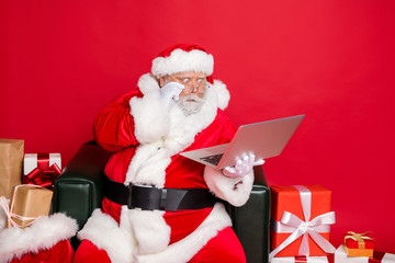 Portrait of astonished santa claus touching his eyewear eyeglasses looking news sales discounts at...