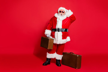 Full length body size view of his he amazed speechless funky fat overweight plump gray-haired bearded man tourist carrying bag isolated over bright vivid shine red background