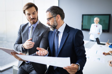 Collaboration and analysis by business people working in office