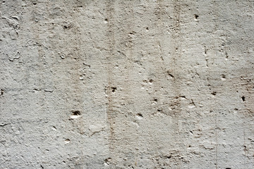 Texture of a concrete wall with cracks and scratches which can be used as a background