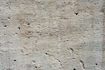 Texture of a concrete wall with cracks and scratches which can be used as a background