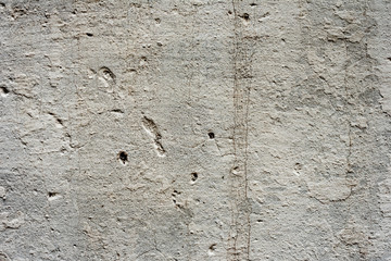 Texture of a concrete wall with cracks and scratches which can be used as a background
