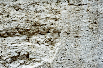 Texture of a concrete wall with cracks and scratches which can be used as a background