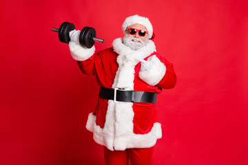Portrait of cheerful cheery confident funky fat overweight plump gray-haired bearded man demonstrating biceps triceps athlete body building isolated over bright vivid shine red background
