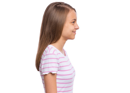 Side view of portrait of teen girl, isolated on white background. Happy child - profile. Smiling schoolgirl looking away. Back to school concept.