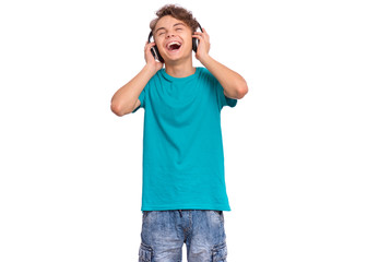 Fototapeta premium Happy teen boy with headphones, isolated on white background. Cheerful child listening to music, singing song and dancing. Emotional portrait of handsome teenager guy enjoying music.