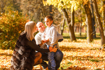 walking family with child in autumn park