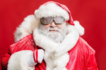 Close up photo of stylish elderly hipster santa carry bag sack ready deliver present in stormy cataclysm wear white gloves fur sleeves cap isolated over red color background