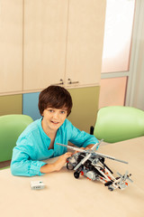 Happy schoolboy showing his new helicopter model.