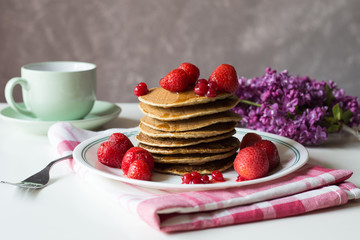 Delicious pancakes with strawberry on brown wooden background