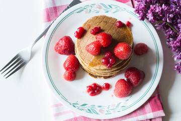 Delicious pancakes with strawberry on brown wooden background
