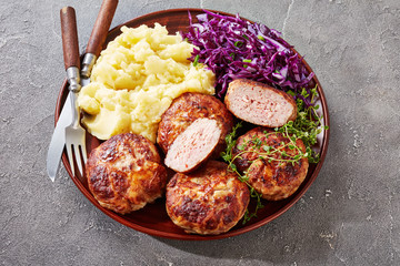 crepinette with potato mash and cabbage salad