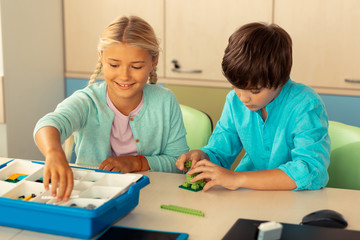 Classmates building figures during their school lesson.