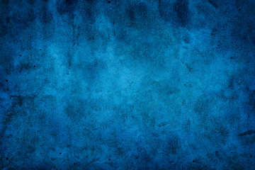 Fototapeta na wymiar Rustic blue wall background with darker black grungy border and vintage texture design.