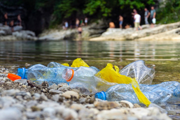Plastic pollution in water. Dirty plastic bottles in a river. Pollution and recycle concept