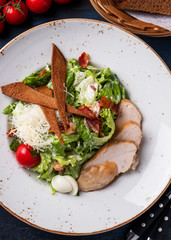 Caesar salad with chicken and vegetables. Top view. Closeup