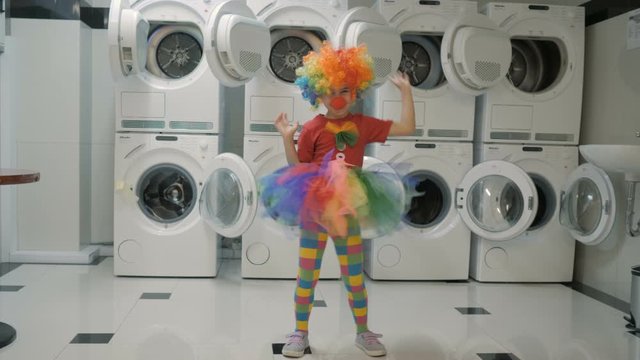 Happy Clown Little Girl Dancing And Have Fun In the Laundry Room. Little Child Clown Enjoying Dance, Having Fun Together, Party. Floss Dance Viral, Flossing.