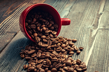 Red coffee cup on wooden desk - morning coffee mood
