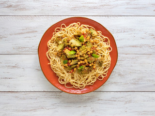 Pasta with romanesco cauliflower (broccoli) on a white wooden table.
