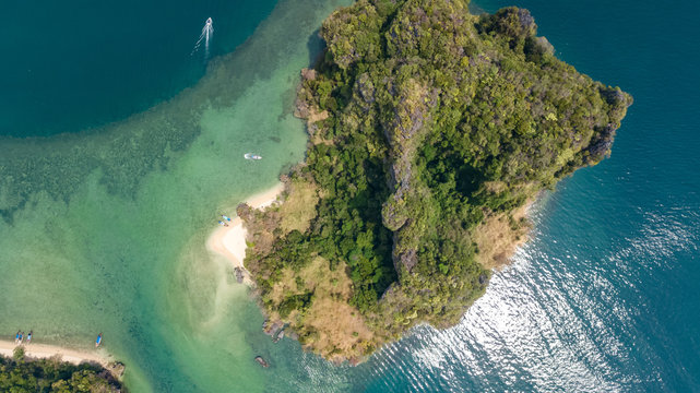 Aerial drone view of tropical islands, beaches and boats in blue clear Andaman sea water from above, beautiful archipelago islands of Krabi, Thailand