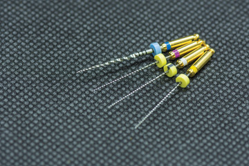 endodontic needles for the treatment of pulpitis and tooth roots close-up on a black background....