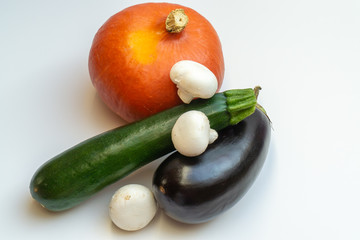 Pumpkin, eggplant, mushrooms and courgette on white background