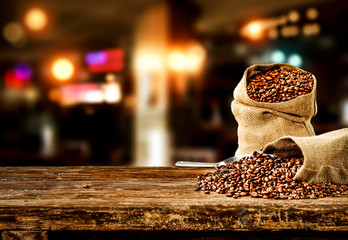 Fresh coffee in sacks in cafe interior. Free space for your product. 