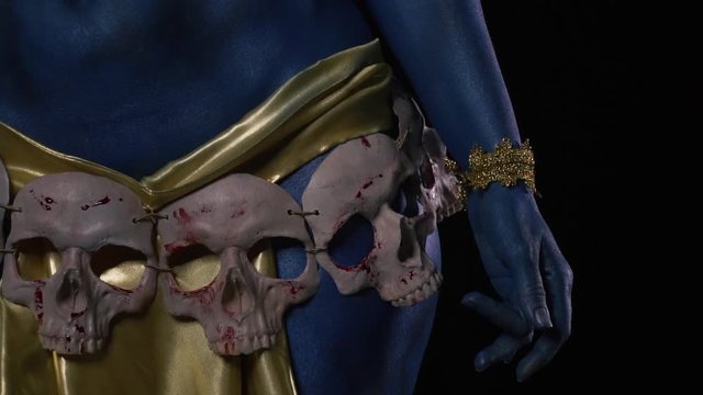 Close up of the skulls and golden clothes on the goddess Kali