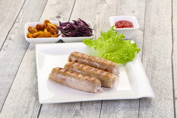 Grilled sausages served mushrooms and cabbage