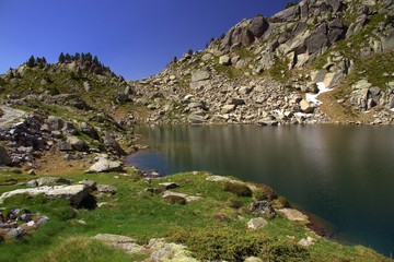 Summer view of the beautiful Gran d’Amitges lake at an altitude of 2365 m, Aiguestortes i Estany de Sant Maurici National Park, Catalonia, Spain