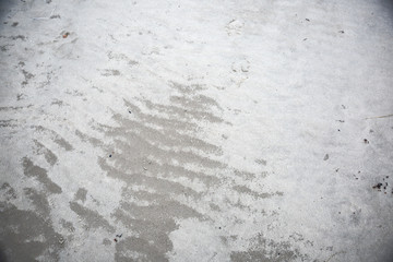 Sand texture on the beach. Cold seaside background.
