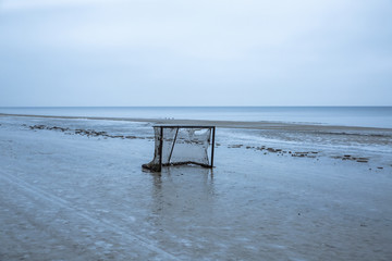 Abandoned football net on the winter beach.