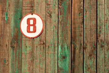 the number eight on the old wooden gate