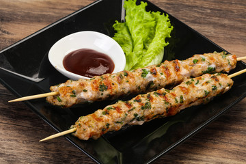 Minced pork skewer kebab with sauce
