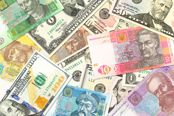 Fototapeta na wymiar some ukrainian hryvnia banknotes and american dollar banknotes mixed indicating bilateral economic relations