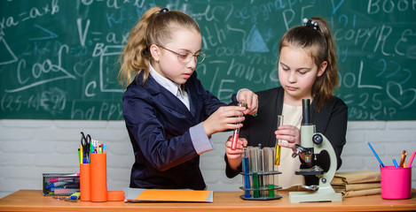 science experiments in laboratory. Chemistry research. Little girls in school lab. Formal school education. Little scientist work with microscope. Biology school lesson. Lethal and dangerous