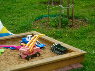 children's toys in the sandbox in spring, Russia.