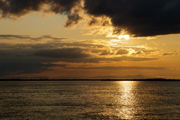 Sunset with black clouds on the Amur River